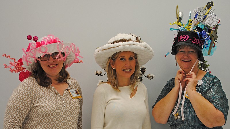 MaryEllen Locher Breast Center outreach coordinator Angela Posey, volunteer Gina Bryan and outreach assistant Debbie Keith, from left, model the new Hats Off to Breast Health hats made by Bryan. (Contributed photo)