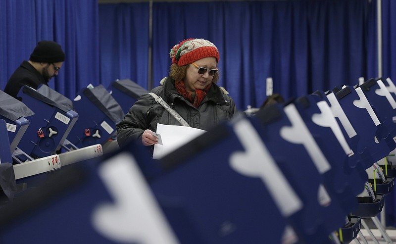 
              In this Tuesday, March 13, 2018 photo, Chicago resident Sonja Russell walks up to a voting machine to cast her ballot in Illinois primary elections at the city's new early voting super site in downtown Chicago. In Illinois, attempts by hackers in the summer of 2016 to alter information were ultimately unsuccessful, although voter data was viewed. (AP Photo/Kiichiro Sato)
            