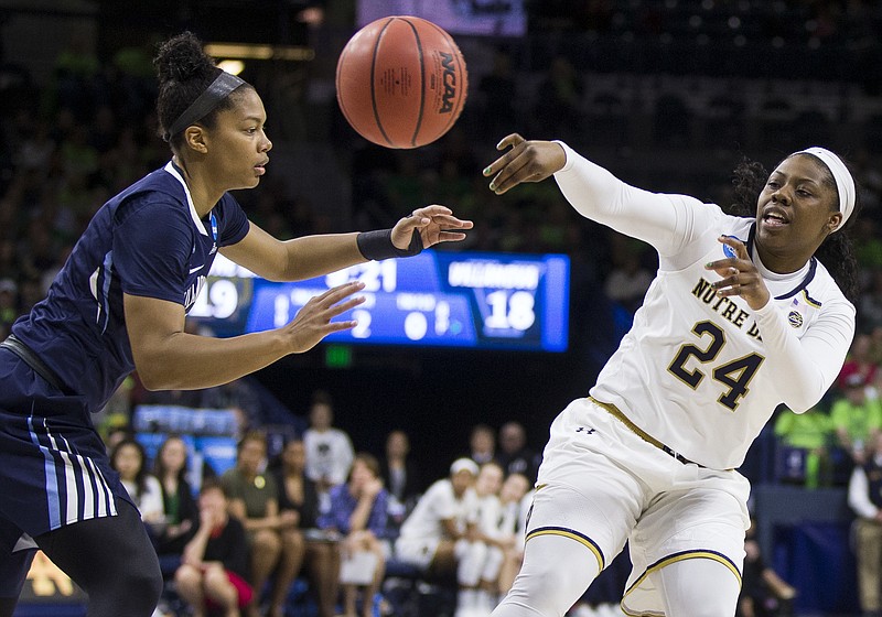 Notre Dame's Arike Ogunbowale, right, passes around Villanova's Jannah Tucker, left, during a second-round game in the NCAA women's college basketball tournament Sunday, March 18, 2018, in South Bend, Ind. (AP Photo/Robert Franklin)