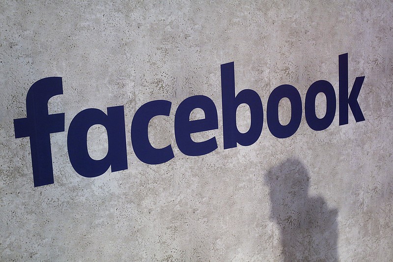 This Jan. 17, 2017, file photo shows a Facebook logo being displayed in a start-up companies gathering at Paris' Station F, in Paris. A former employee of a Trump-affiliated data-mining firm says it used algorithms that "took fake news to the next level" using data inappropriately obtained from Facebook. (AP Photo/Thibault Camus, File)