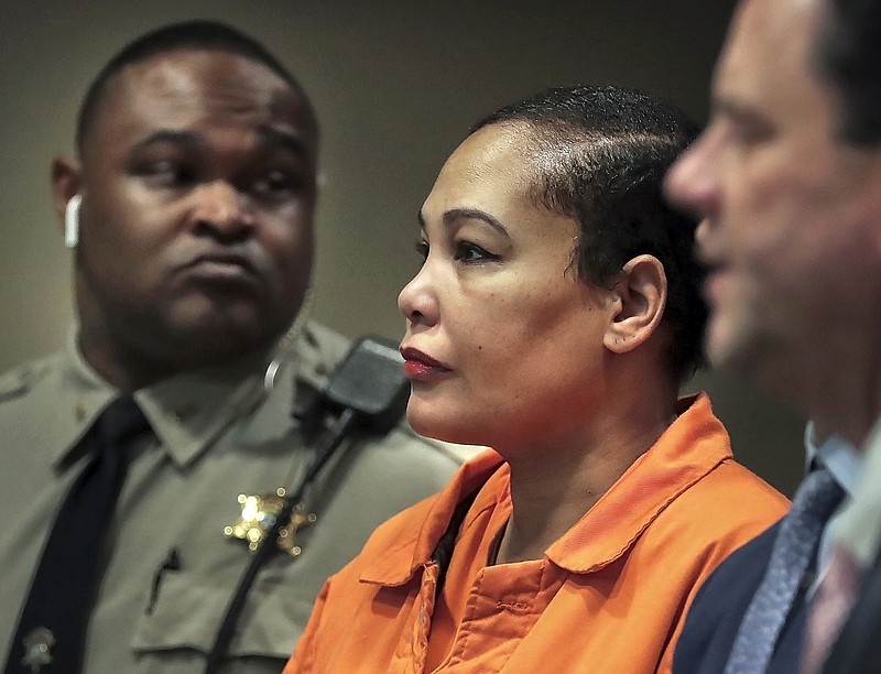 FILE - In this Feb. 26, 2018, file photo, Sherra Wright, center, appears in court with attorney Steve Farese Jr., right, in Memphis, Tenn. The ex-wife of former NBA player Lorenzen Wright won’t face the death penalty if convicted of killing him more than seven years ago in Tennessee, a prosecutor said Monday, March 19, 2018. Shelby County prosecutor Paul Hagerman told a judge during a hearing that Sherra Wright won’t face a death sentence if found guilty of first degree murder in her ex-husband’s shooting death. She is being held without bond and has pleaded not guilty in one of the most high-profile murder cases in Memphis’ history. (Jim Weber/The Commercial Appeal via AP, File)