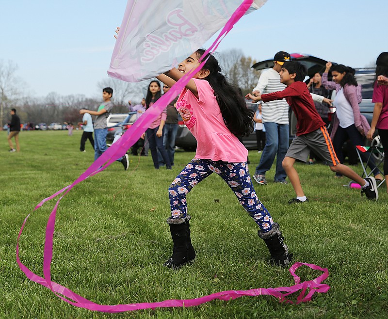 Shrini Patel, 6, throws her kite into the air during the CIFA Kite Festival Sunday, March 18, 2018 at the Tennessee Riverpark along Amnicola Highway in Chattanooga, Tenn. The festival is traditionally held on January 14 or 15, but due to the weather being too cold at that time in Chattanooga, the event was held in March. 