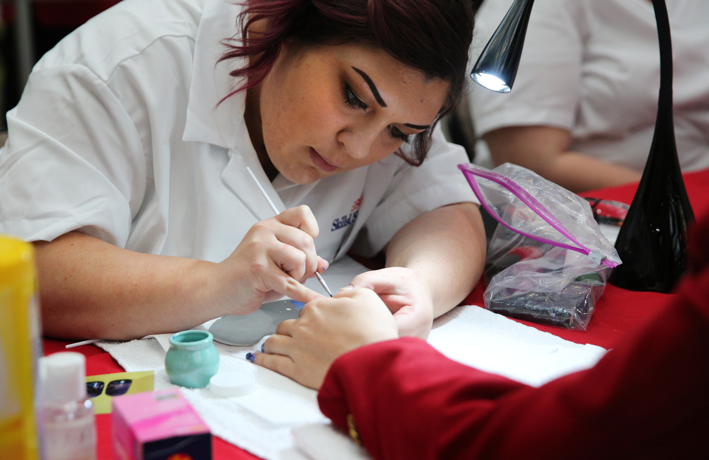 Mary Rochester, a Tennessee College of Applied Tech-Hohenwald student, works on an individual's nails during a competition at the Tennessee State Leadership and Skills Conference at the Chattanooga Convention Center on Tuesday, March 20, 2018 in Chattanooga, Tenn. A variety of competitions, including cosmetology, carpentry, graphic design and more, were held during the event with the winners advancing to a national competition.