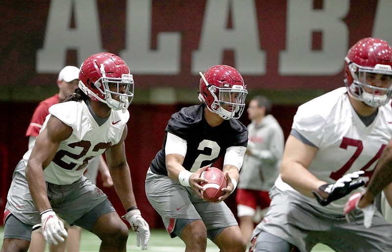 Alabama junior quarterback Jalen Hurts takes a snap during Tuesday's start to spring practice in Tuscaloosa.