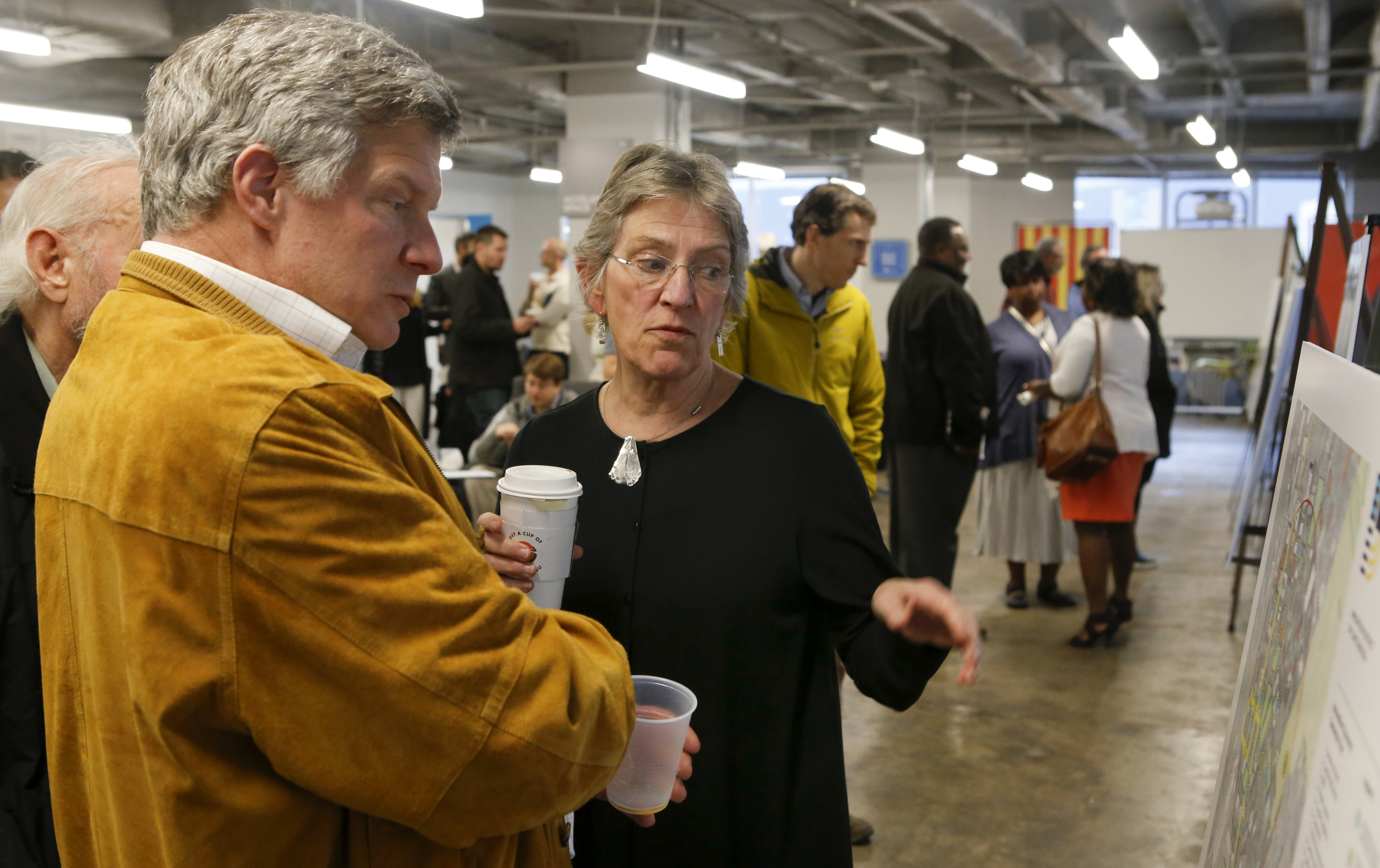 Mike Cooper, left, speaks with Ann Coulter, of A. Coulter Consulting, during a public meeting on the framework for the Innovation District on the Fifth Floor of the Edney Innovation Center on Tuesday, March 20, 2018 in Chattanooga, Tenn.