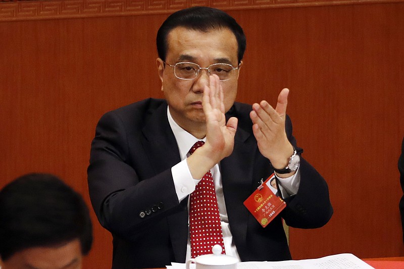 
              Chinese Premier Li Keqiang applauds during the closing session of the annual National People's Congress in the Great Hall of the People in Beijing, China, Tuesday, March 20, 2018. (AP Photo/Ng Han Guan)
            