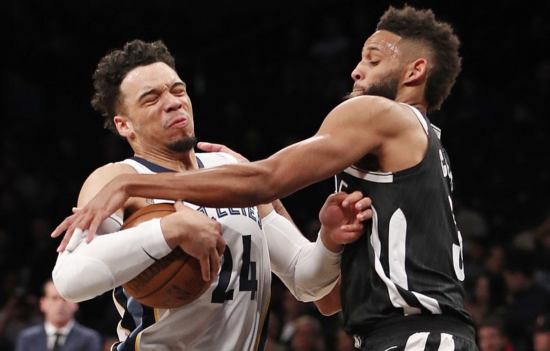 Brooklyn Nets guard Allen Crabbe (33) tries to strip the ball from Memphis Grizzlies forward Dillon Brooks (24) as Brooks drives to the basket during the first half of an NBA basketball game, Monday, March 19, 2018, in New York. (AP Photo/Kathy Willens)