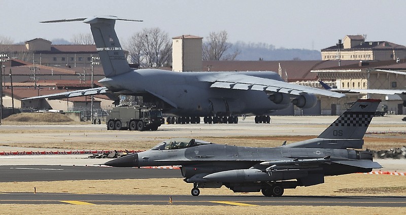 A U.S. Air Force F-16 fighter jet, bottom, lands at the Osan U.S. Air Base in Pyeongtaek, South Korea, Tuesday, March 20, 2018. At a potentially pivotal moment of diplomacy with North Korea, the Pentagon said Monday that annual U.S.-South Korean military exercises that had been postponed for the Pyeongchang Winter Olympics will begin April 1. (Hong Gi-won/Yonhap via AP)