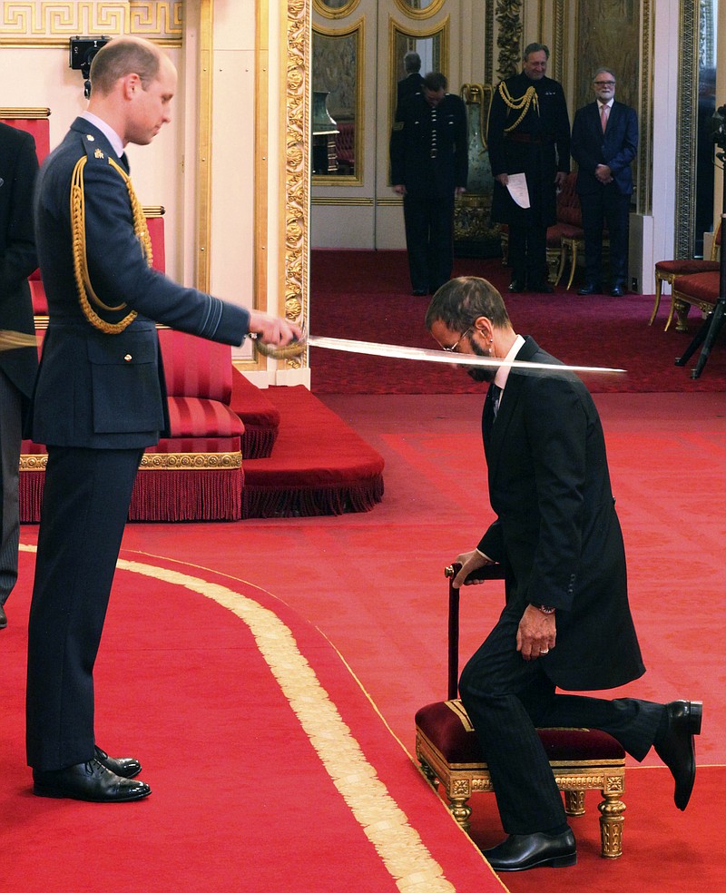 Former Beatle Ringo Starr, is made a knight by Britain's Prince William at Buckingham Palace during an Investiture ceremony in London Tuesday March 20, 2018. (Yui Mok/PA via AP)
