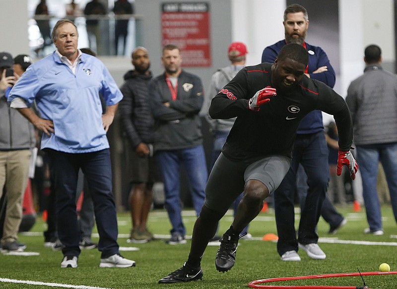 New England Patriots head coach Bill Belichick watches Georgia linebacker Roquan Smith (3) run a drill during Georgia Pro Day, Wednesday, March 21, 2018, in Athens. Pro Day is intended to showcase talent to NFL scouts for the upcoming draft. (Joshua L. Jones/Athens Banner-Herald via AP)