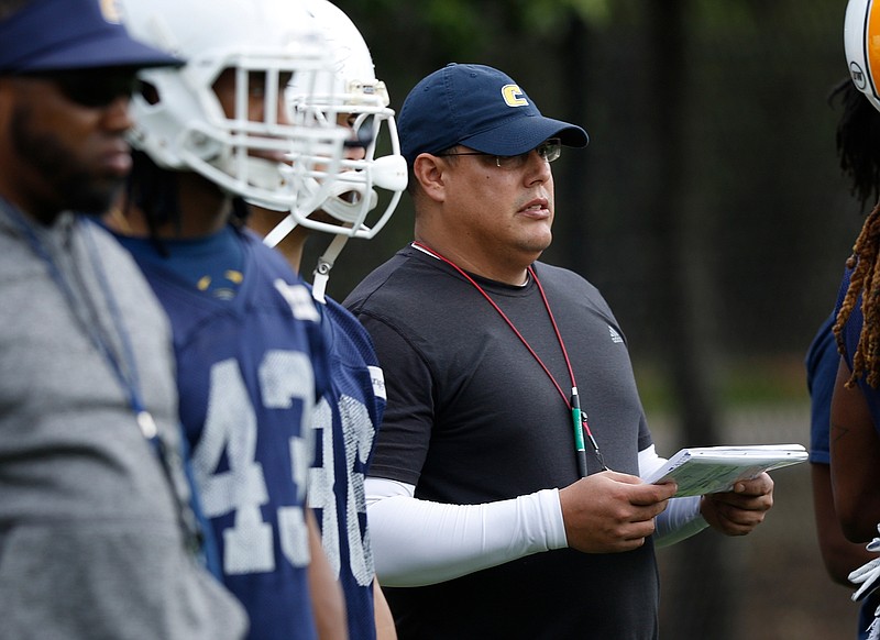 Inside linebackers coach Oscar Rodriguez watches players during the UTC football team's first spring practice at Scrappy Moore Field on Feb. 24. He said his unit has "shown flashes at times" since then.