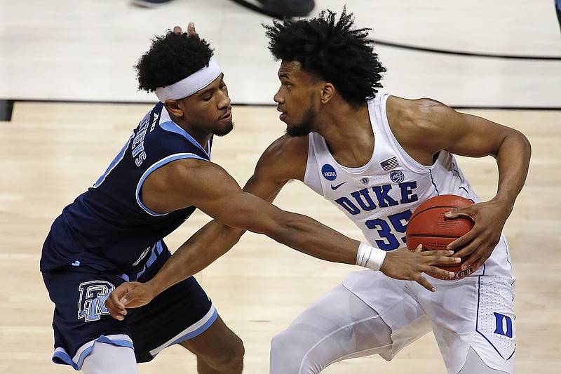 Duke's Marvin Bagley III (35) is defended by Rhode Island's E.C. Matthews during the second half of an NCAA men's college basketball tournament second-round game, in Pittsburgh, Saturday, March 17, 2018. Duke won 87-62. (AP Photo/Gene J. Puskar)