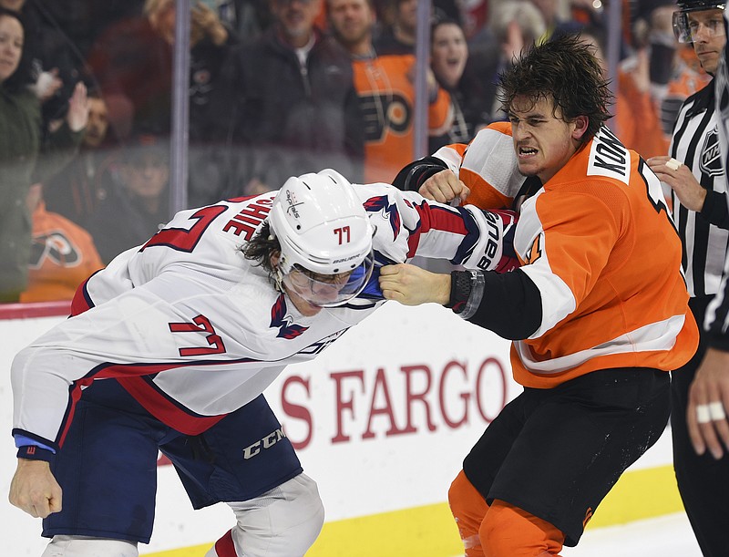 
              FILE  - This March 18, 2018 file photo shows Washington Capitals' T.J. Oshie, left, fighting Philadelphia Flyers' Travis Konecny during the third period of an NHL hockey game in Philadelphia. A tight race among contenders in the Metropolitan Division should have the top five teams battle-tested and playoff-ready. The Washington Capitals, Pittsburgh Penguins, Philadelphia Flyers, Columbus Blue Jackets and New Jersey Devils could all make it and are already in playoff mode. And the Metropolitan playoff series should be as tight as this season. (AP Photo/Derik Hamilton)
            