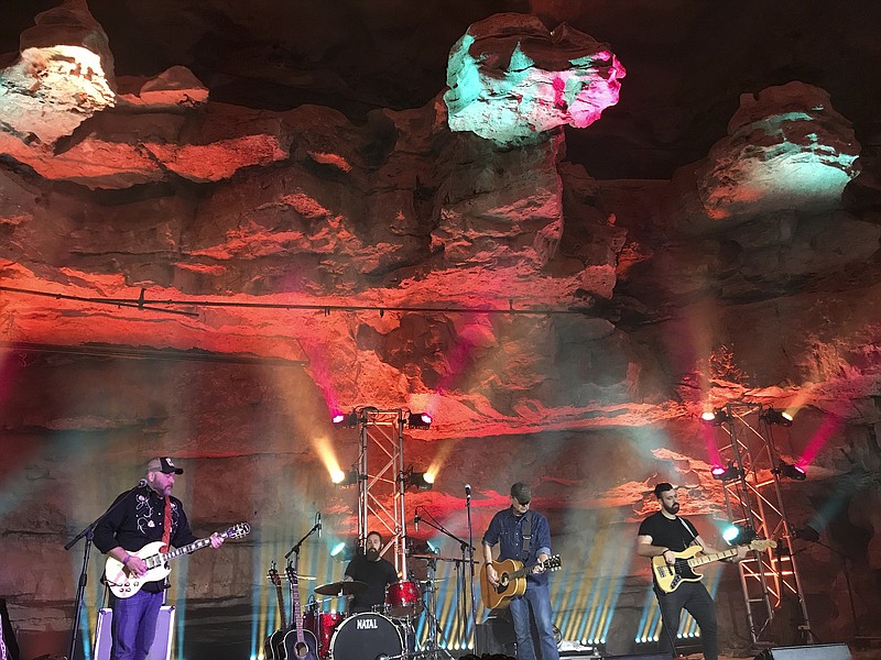 In this Feb. 25, 2018 photo, singer-songwriter Chris Knight, center, and his band perform 333 feet below ground in Cumberland Caverns near McMinnville, Tenn. Tennessee will soon have not just one, but two caves vying for fans who want to see music performed in a subterranean environment.(AP Photo/Jeff Martin)

