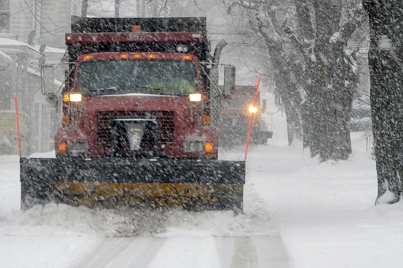 Two plows from Hazleton's Department of Public Works clear the snow tandem style from West Fern Street in Hazleton, Pa., Wednesday, March 21, 2018. A spring nor'easter targeted the Northeast on Wednesday with strong winds and a foot or more of snow expected in some parts of the region. (Ellen F. O'Connell/Hazleton Standard-Speaker via AP)