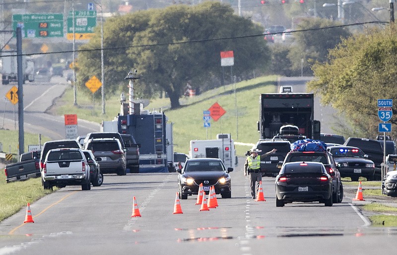 Officials work at a blocked off area near where a suspect in a series of bombing attacks in Austin blew himself up as authorities closed in, Wednesday, March 21, 2018, in Round Rock, Texas. (Ricardo B. Brazziell/Austin American-Statesman via AP)