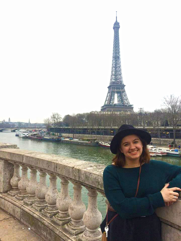 Carson Cook pauses during her morning stroll along the Seine to pose for photos with the Eiffel Tower.