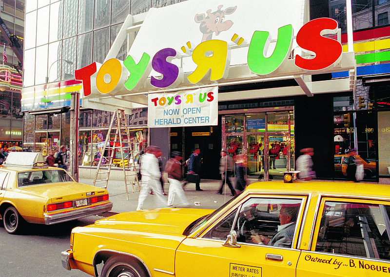 Pedestrians pass under the Toys R Us marquee in New York before its grand opening on Nov. 17, 1990. Toys R Us CEO David Brandon told employees on March 14, 2018, that the company's plan is to liquidate all of its U.S. stores. (AP File Photo/Richard Drew File)