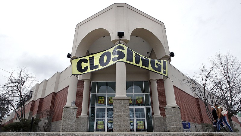 FILE- In this Feb. 23, 2018, file photo, customers enter a Bon Ton store, which is scheduled to close, in Concord, N.H. Shoppers need to compare prices as they navigate the sales racks, and carefully check the quality of the merchandise since they can’t return items. (AP Photo/Charles Krupa, File)