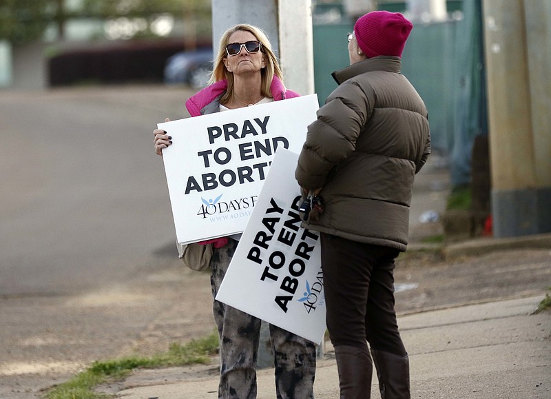 Pro-life supporters stand with their signs outside the Jackson Women's Health Organization clinic in Jackson, Miss., the state's only abortion clinic.