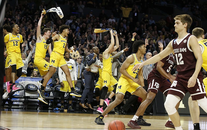 Michigan players celebrate during the second half of an NCAA men's college basketball tournament regional semifinal against Texas A&M on Thursday, March 22, 2018, in Los Angeles. (AP Photo/Alex Gallardo)