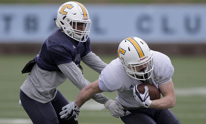 UTC defensive back C.J. Fritz, left, stops wide receiver Bryce Nunnelly during practice at Finley Stadium on Monday.