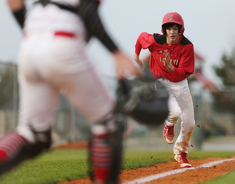 Lakeview Fort-Oglethorpe's Nelson Chapman (7) runs home to score on a hit during the Lakeview Fort-Oglethorpe vs. Sonoraville baseball game Friday, March 23, 2018 in Sonoraville, Ga. 