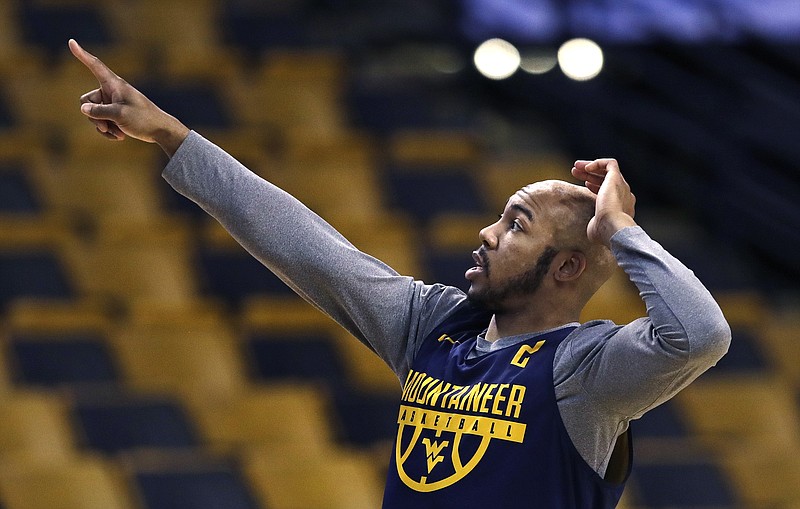 West Virginia's Jevon Carter points towards the scoreboard prior to a practice at the NCAA men's college basketball tournament in Boston, Thursday, March 22, 2018. West Virginia faces Villanova in a regional semifinal on Friday night. (AP Photo/Charles Krupa)