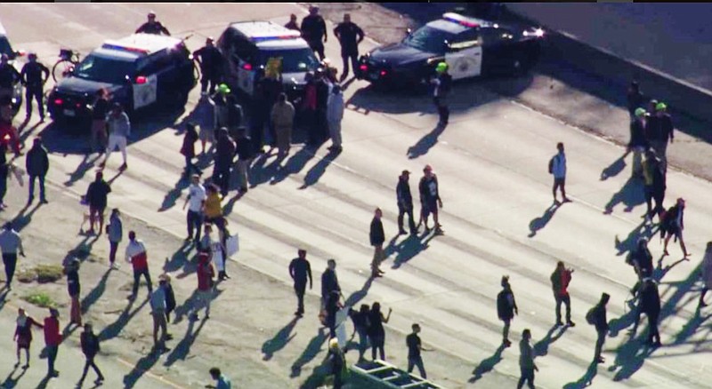 This photo from video provided by KCRA3 shows demonstrators protesting this week's fatal shooting of an unarmed black man and shutting down the Interstate 5 Freeway through downtown Sacramento, Calif., Thursday, March 22, 2018. Hundreds of people rallied for Stephon Clark, a 22-year-old who was shot Sunday in his grandparents' backyard. Police say they feared he had a handgun when they confronted him after reports that he had been breaking windows, but he only had a cellphone. (KCRA3 via AP)