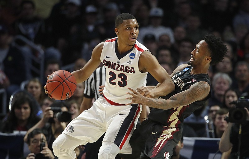 Gonzaga guard Zach Norvell Jr. (23) works against Florida State guard Braian Angola during the first half of an NCAA men's college basketball tournament regional semifinal Thursday, March 22, 2018, in Los Angeles. (AP Photo/Jae Hong)