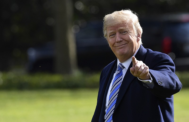 President Donald Trump walks across the South Lawn of the White House in Washington, Friday, March 23, 2018, as he heads to Marine One of a short trip to Andrews Air Force Base. 