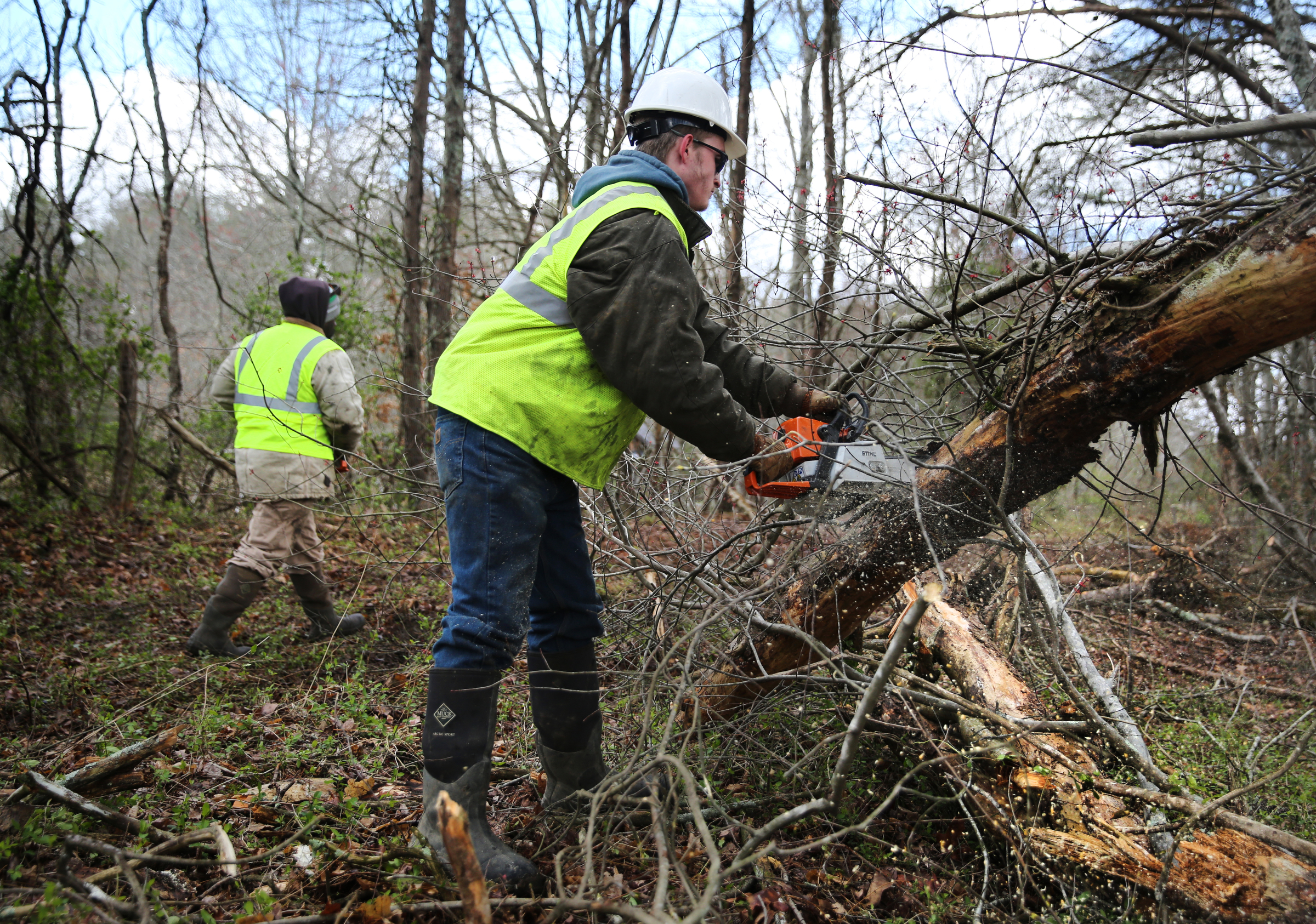Kenneth Brooks and Daniel Johnson, chainsaw operators with TREED and Associates, chop up trees across the Mountain Goat Trail Wednesday, March 21, 2018 in Tracy City, Tenn. The multi-use walking and cycling trail will eventually link seven towns in Grundy and Franklin counties.