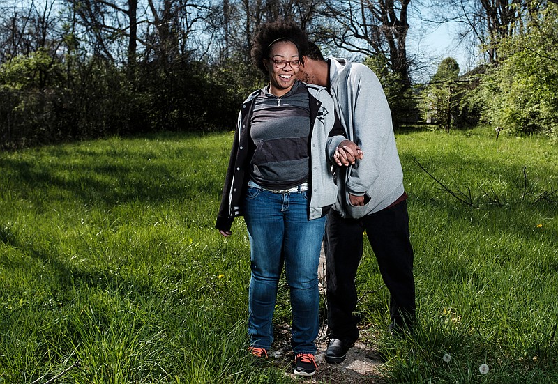 Lynesha Flanigan, left, and her husband Michael pose for a portrait in their new vacant lot in the Boyce Station neighborhood on Thursday, March 22, 2018, in Chattanooga, Tenn. The Boyce Station Neighborhood Association is working with neighborhood families to obtain vacant lots and build affordable housing.