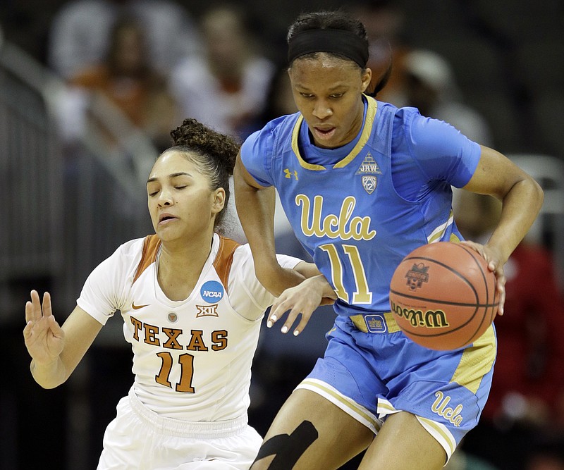 UCLA forward Lajahna Drummer, right, prevents a steal by Texas guard Brooke McCarty, left, during the first half of a women's NCAA college basketball tournament regional semifinal game, Friday, March 23, 2018, in Kansas City, Mo. (AP Photo/Orlin Wagner)