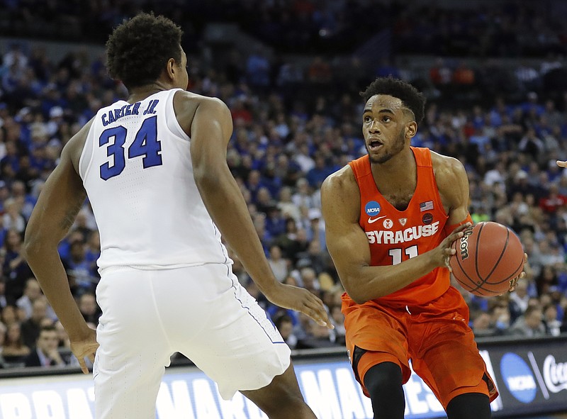 Syracuse's Oshae Brissett, right, heads to the basket as Duke's Wendell Carter Jr (34) defends during the second half of a regional semifinal game in the NCAA men's college basketball tournament Friday, March 23, 2018, in Omaha, Neb. (AP Photo/Charlie Neibergall)