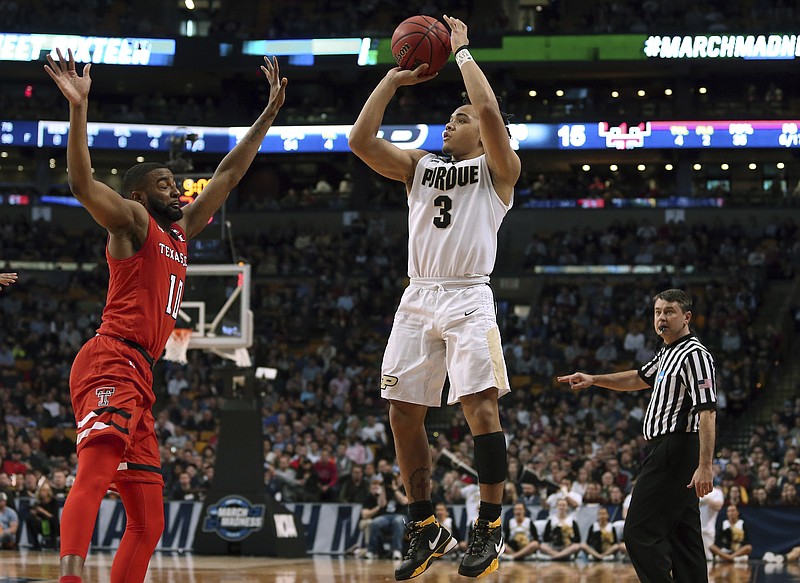 Purdue's Carsen Edwards, right, shoots against Texas Tech's Niem Stevenson during the first half of an NCAA men's college basketball tournament regional semifinal Friday, March 23, 2018, in Boston. (AP Photo/Mary Schwalm)