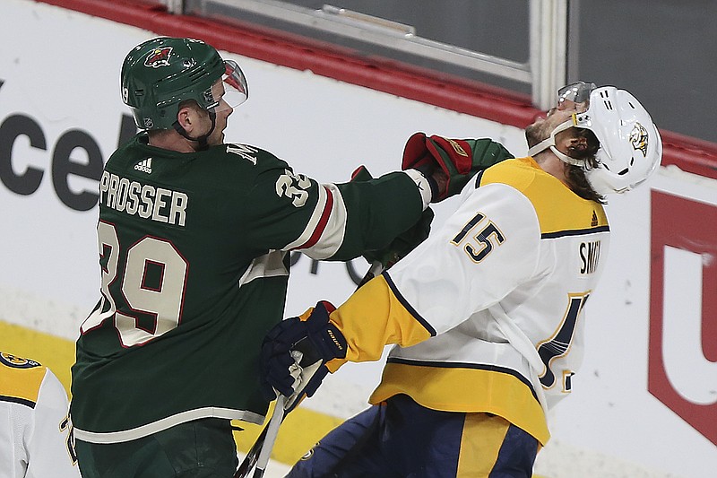 Minnesota Wild's Nate Prosser (39) shoves Nashville Predators' Craig Smith (15) in the first period of an NHL hockey game Saturday, March 24, 2018, in St. Paul, Minn. (AP Photo/Stacy Bengs)