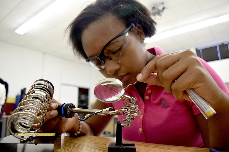 Brookeana Williams practices soldering wire in August 2015. Tyner Academy teacher Bryan Robinson started a mechatronics program
that offers students the opportunity to graduate with a certification that will aid them in finding jobs with tech companies.