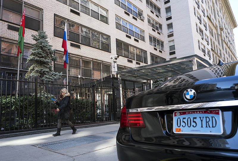 A woman walks past the Permanent Mission of the Russian Federation in New York Monday, March 26, 2018. The United States and more than a dozen European nations kicked out Russian diplomats on Monday and the Trump administration ordered Russia's consulate in Seattle to close, as the West sought joint punishment for Moscow's alleged role in poisoning an ex-spy in Britain. (AP Photo/Craig Ruttle)