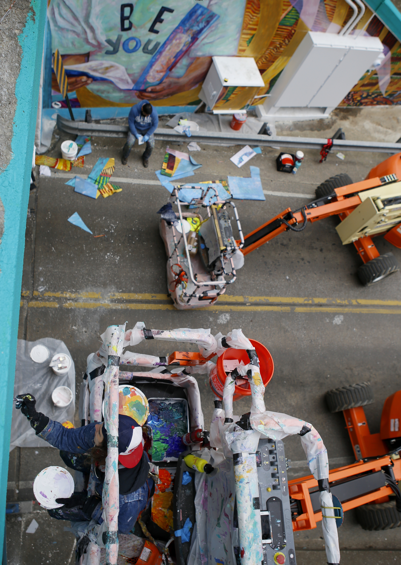 Greta McLain, bottom, works on painting over the seams of the mural on the east end of the Wilcox Tunnel on Monday, March 26, 2018 in Chattanooga, Tenn. McLain is the lead artist and owner of GoodSpace Murals out of Minneapolis.