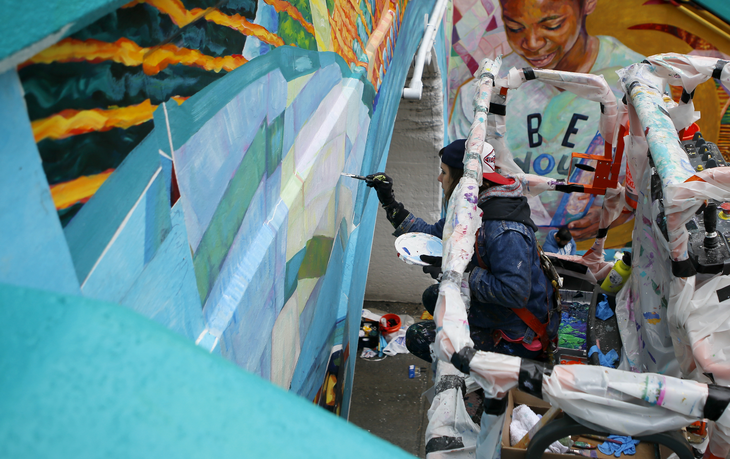 Greta McLain works on painting over the seams of the mural on the east end of the Wilcox Tunnel on Monday, March 26, 2018 in Chattanooga, Tenn. McLain is the lead artist and owner of GoodSpace Murals out of Minneapolis.
