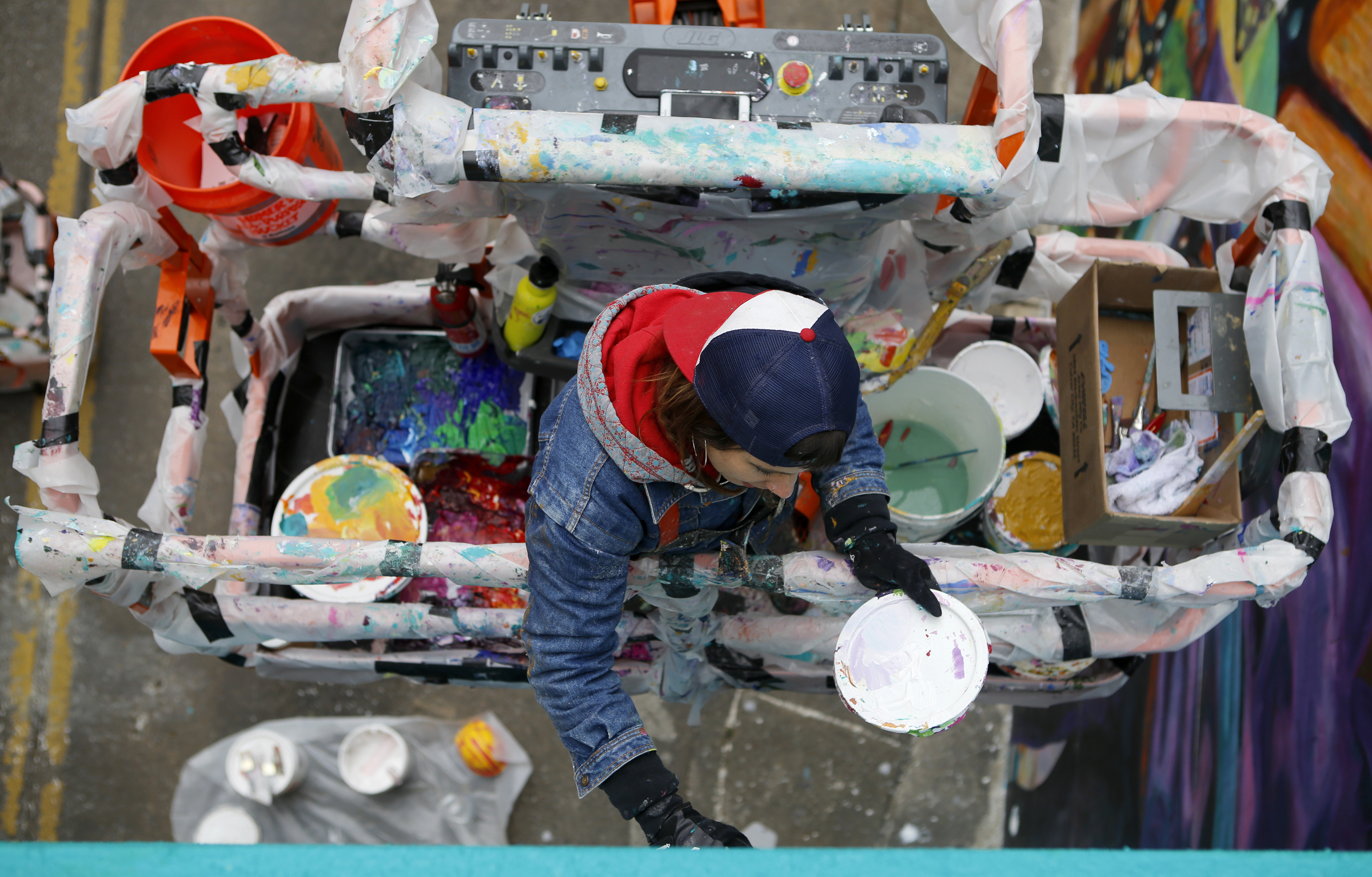 Greta McLain works on painting over the seams of the mural on the east end of the Wilcox Tunnel on Monday, March 26, 2018 in Chattanooga, Tenn. McLain is the lead artist and owner of GoodSpace Murals out of Minneapolis.
