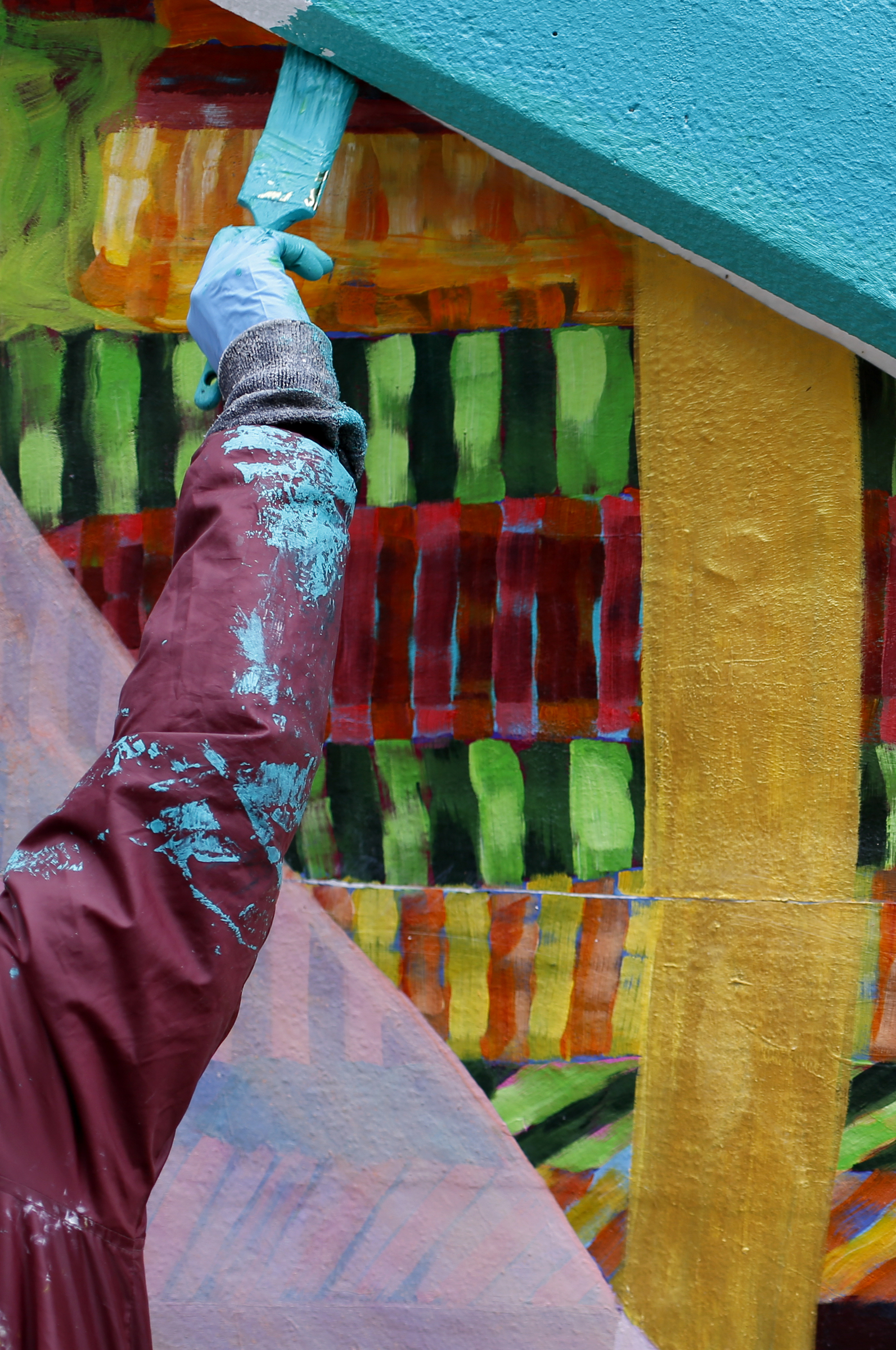Local artist Mercedes Llanos works on painting on the top of the tunnel abutment on the east end of the Wilcox Tunnel on Monday, March 26, 2018 in Chattanooga, Tenn. Llanos was working with the GoodSpace Murals crew out of Minneapolis.