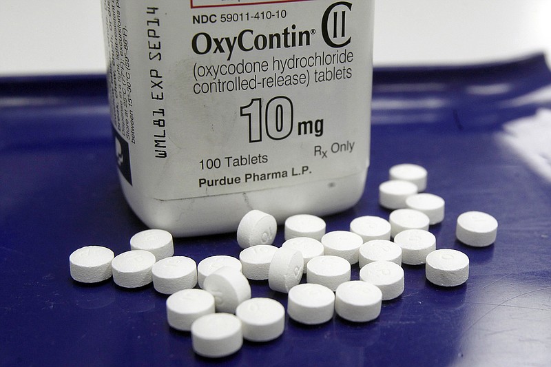 FILE - This 2013 file photo shows OxyContin pills arranged for a photo at a Vermont pharmacy. (AP Photo/Toby Talbot, File)