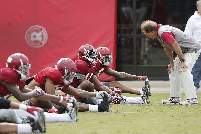 Alabama football coach Nick Saban talks to players before last Saturday's practice in Tuscaloosa. The Crimson Tide worked out in full pads for the first time this spring on Tuesday afternoon.