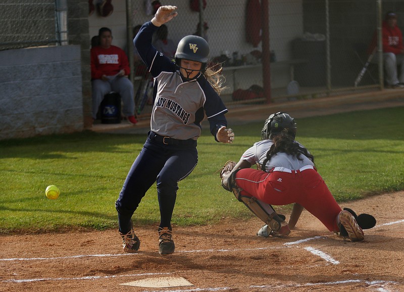 Walker Valley runner Laney Harris is safe at home after a wild throw to Ooltewah catcher Cheyanne Sales during their prep softball game at Ooltewah High School on Tuesday, March 27, 2018, in Ooltewah, Tenn. 