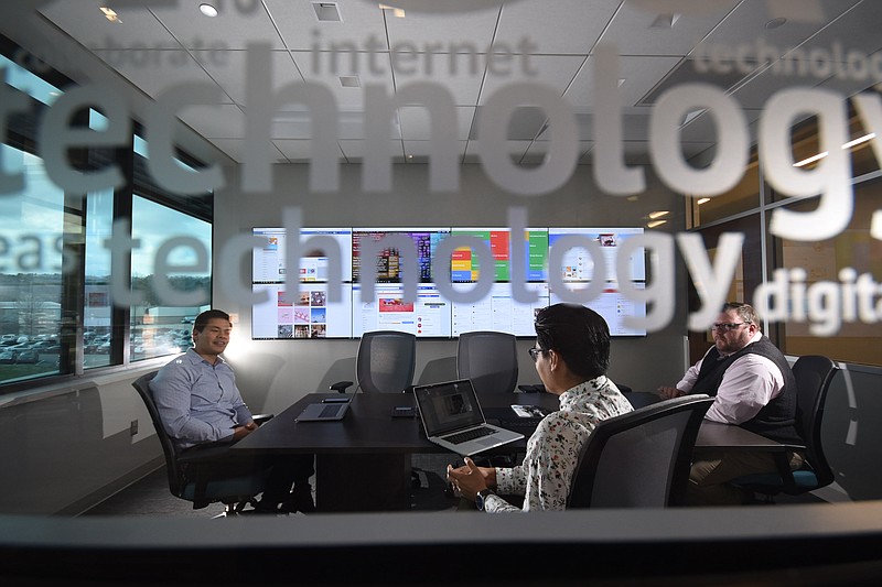 McKee Foods David Blair, left, marketing and advertising specialist, Bryant Rodriguez, digital and social media strategist, and Mike Gloekler, corporate communications and public relations manager, work in the media room at the Collegedale headquarters.