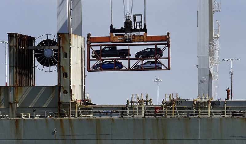 FILE - In this July 13, 2017, file photo, a crane transporting vehicles operates on a container ship at the Port of Oakland, in Oakland, Calif. The Trump administration said Tuesday, March 27, 2018, it has widened U.S. access to South Korea’s car market while providing American manufacturers protection from South Korean imports. (AP Photo/Ben Margot, File)