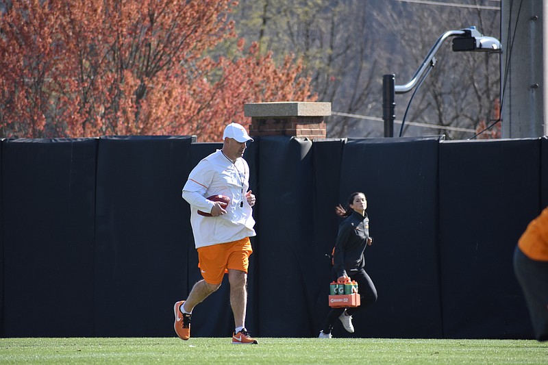 Tennessee head coach Jeremy Pruitt runs between drills at football practice on March 22, 2018.