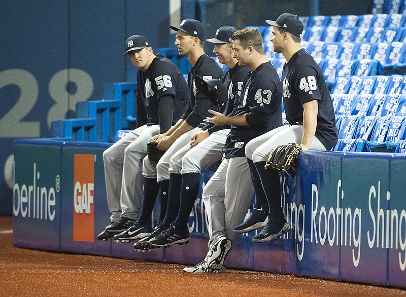 New York Yankees players watch batting practice during a baseball workout in Toronto, Wednesday, March 28, 2018.  The Yankees face the Toronto Blue Jays on opening day Thursday. (Nathan Denette/The Canadian Press via AP)